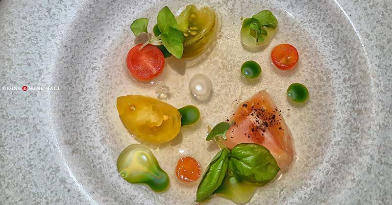 Chef Ryan Clift's Tomato Water: Clear broth, cherry tomatoes, microgreens on grey plate.