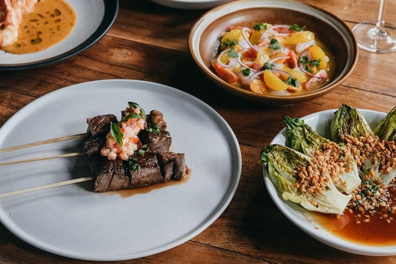 A table spread with sharing dishes of starters and mains at HOME by Chef Wayan.