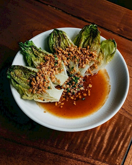 Lettuce Bakar - Grilled baby romaine, tamarind, palm sugar vinaigrette, topped with tempe crumble at HOME by Chef Wayan
