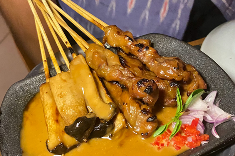 Savory Sate Khas Senayan skewers, ready to be dipped in the rich peanut sauce.