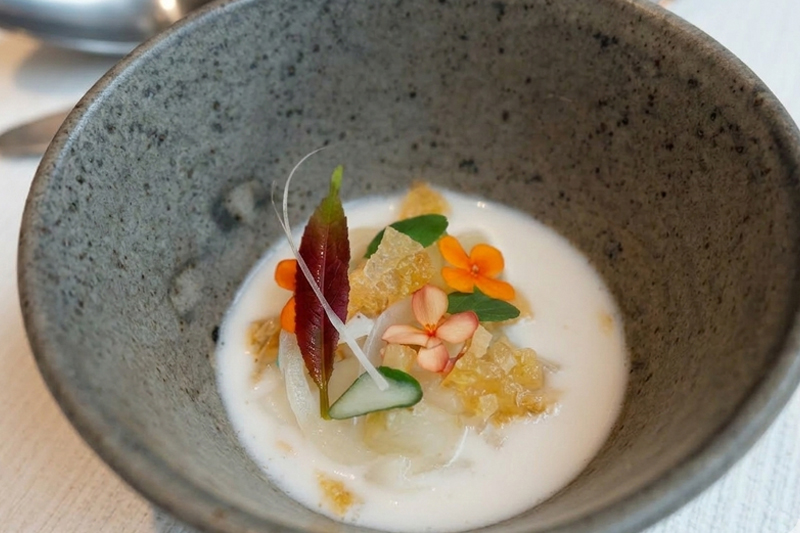 Sepia with black garlic, citrus kosho, and edible flowers at Syrco BAS&Egrave; Ubud tasting menu